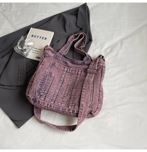 Close-up of purple washed denim tote bag showing vertical stitching and texture