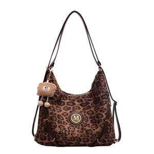 Large leopard print tote bag with brown leather straps and cute plush charm pendant