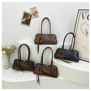 Detail view of retro baguette bags in brown and black with leather texture and bear charms