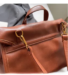 Close-up of retro brown backpack with high-quality golden metal hardware and leather texture