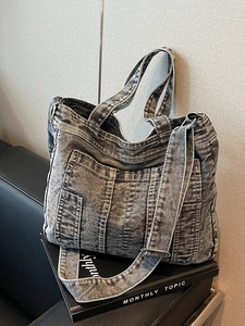 Grey washed denim tote bag with vintage texture and adjustable wide shoulder strap