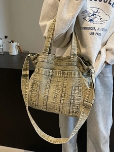 Large vintage washed denim tote bag with multi-pocket design and adjustable shoulder strap