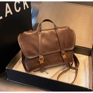 Detail of vintage dark brown faux leather tote with FREE 1991 embossed logo and buckles