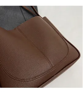 Close-up of brown litchi pattern leather showing soft texture and stitching detail