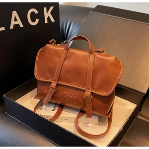 Detail of vintage brown leather backpack with magnetic flap and FREE 1981 COLOR logo