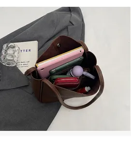 Brown lychee leather tote interior showing tablet, umbrella and makeup for daily commuting