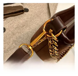 Detail showing vintage bronze chain and hook on dark brown matte shoulder bucket bag