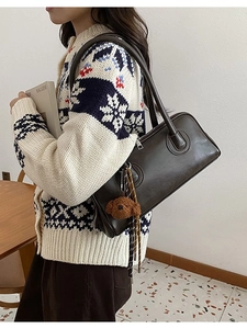Dark brown faux leather baguette shoulder bag with plush bear charm and woven keychain