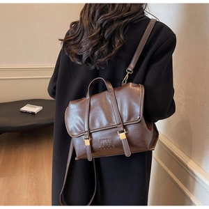 Detail of vintage brown leather backpack with FREE 1981 COLOR embossed logo and metal buckles