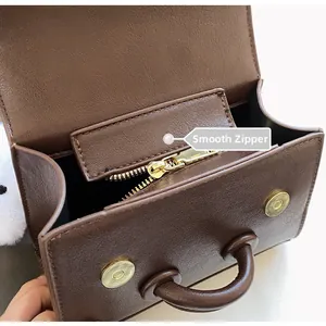 Detail of smooth gold zipper and premium textured leather on a vintage shoulder bag