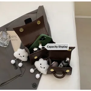 Capacity display of retro brown leather handbags with magnetic buckle and golden hardware