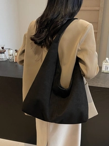 Large vintage black leather hobo tote bag with wide shoulder strap shown on model