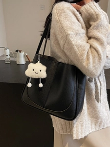 Classic black litchi pattern leather tote bag with a white plush cloud smile charm