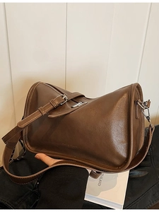 Vintage dark brown leather pillow handbag with silver zipper and adjustable strap
