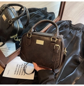 Close-up of retro brown handbag with premium golden hardware and mirror reflection detail