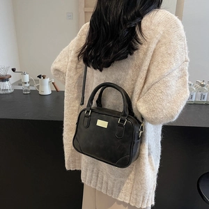 Vintage black leather crossbody handbag with gold hardware for a chic aesthetic look