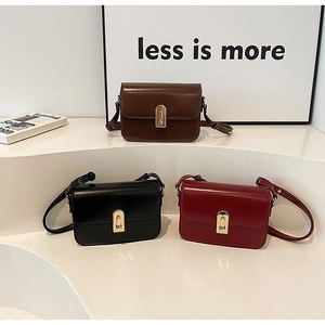 Detailed view of vintage small square crossbody bags in black, brown and burgundy colors