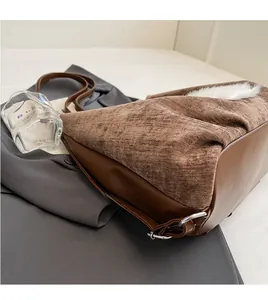 Detail of dark brown corduroy tote bag with white plush trim and long shoulder strap