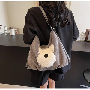 Detail of grey velvet tote bag with white plush dog design on a female model