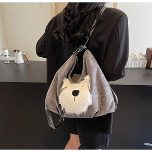 Detail of grey corduroy tote bag featuring a cute 3D plush dog design and leather strap