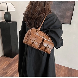 Detail of vintage brown bowling bag featuring twin front pockets and antique hardware