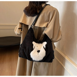 Detailed back view of a black corduroy tote bag with plush schnauzer dog design