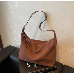 Detail der Hobo-Tasche aus Wildleder mit Lederriemen und langem Reißverschluss-Anhänger