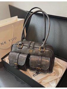 Retro charcoal grey leather shoulder bag with double pockets in a minimalist box setup