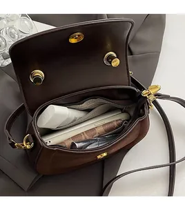 Top view of dark brown crossbody bag interior showing spacious compartments and zipper pocket