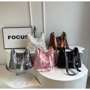 Detailed view of quilted puffer shoulder bags in five metallic colors with tassels
