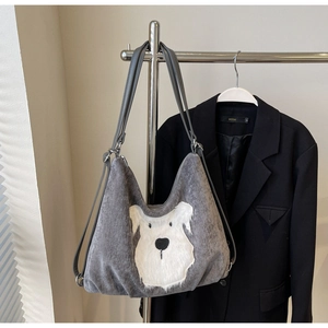 Detail of grey corduroy tote bag featuring a cute white plush puppy patch embroidery