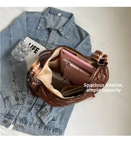 Macro view of spacious brown quilted tote interior showing high storage capacity