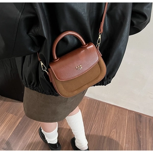Model wearing a brown patchwork crossbody bag with PAN TOR logo and suede texture