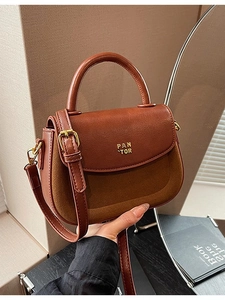 Minimalist brown patchwork leather saddle bag with top handle and crossbody strap
