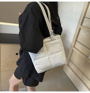 Quilted tote bag detail showing the 3D grid stitching and soft padded texture