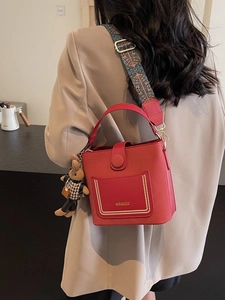 Red retro bucket bag with ethnic embroidery wide strap and plush bunny charm