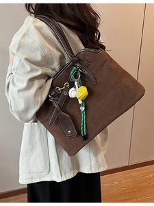 Retro frosted dark brown tote bag with baseball pendant charm and metallic buckle detail
