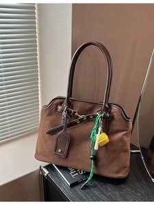 Retro brown suede tote bag with leather straps and decorative green woven charms