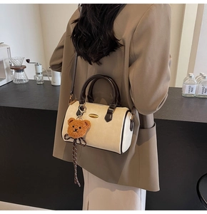 Boston bag detail with brown bear charm and hand-made coffee shop lifestyle vibe