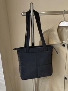 Quilted black shoulder bag with nylon finish for women in a stylish casual commuter style