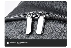 Close-up of black lychee grain leather texture and durable two-way metal zippers on backpack