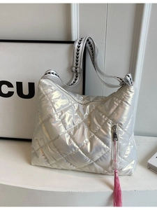 Iridescent silver quilted shoulder bag with patterned strap and pink tassel detail