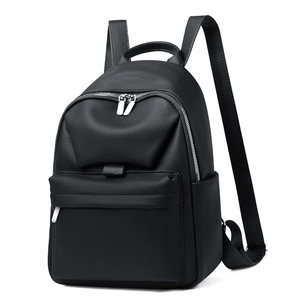 Detail view of black lychee texture leather backpack with side pockets and zippers