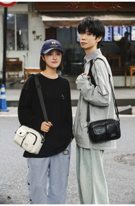 Close-up of stylish crossbody bags in black and white with multi-pocket design