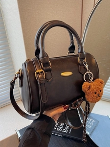 Brown vintage Boston handbag with bear charm and adjustable shoulder strap for women