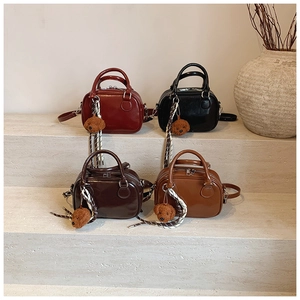 Mini crossbody bags in four colors with teddy bear charms and silk scarves on steps