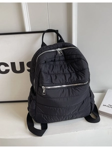 Minimalist black quilted backpack for women with large capacity and silver metal zipper details