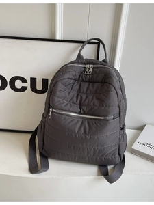 Quilted dark gray nylon backpack with large capacity and puffer texture for daily commuting