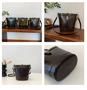 Detail view of stylish leather bucket bags in black, dark brown, and leopard print options