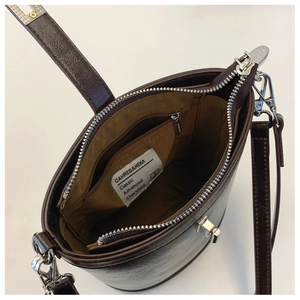 Top view of dark brown bucket bag interior showing smooth lining and zipper pocket